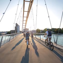 Velofahrer passieren eine Fahrradbrücke in der Stadt Basel