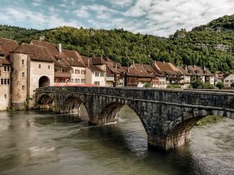 Die Steinbrücke vor St-Ursanne, Doubs Bridge mit Fluss darunter.