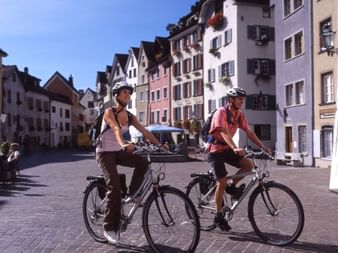 A couple cycling through Chur.