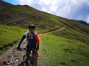 Mountainbikefahrerin auf einem Pfad in einer kargen Landschaft