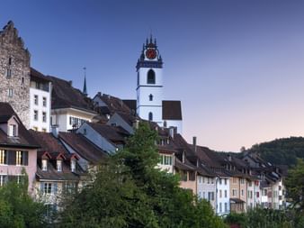 A tall church tower rises above the old town of Aarau.