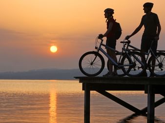 Cyclists enjoy the sunset. Aare route. Cycling holidays with Eurotrek.