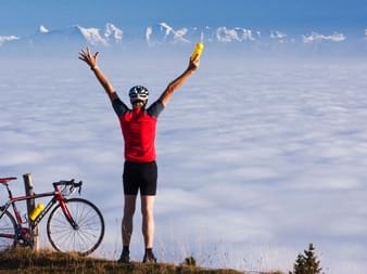 Cyclist celebrating his success. Jura route. Cycling holidays with Eurotrek.