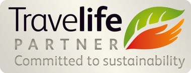Travelife Partner logo with text 'Committed to sustainability' and a symbol combining a green leaf and orange hand on beige background.