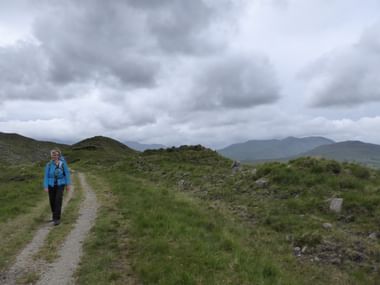 Wanderin auf dem Western Way in Irland bei bewölktem und windigen Wetter.