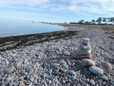 Strand mit Kieselsteinen in Schweden.