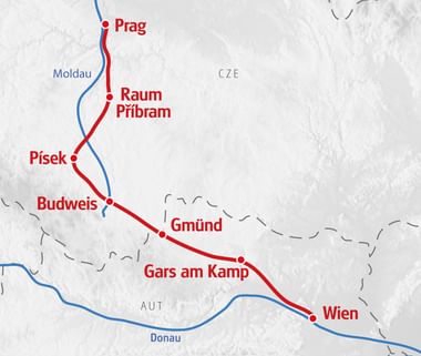 Karte mit Radroute von Prag nach Wien über Raum, Příbram, Písek, Budweis, Gmünd und Gars am Kamp. Blaue Linie zeigt Moldau und Donau.