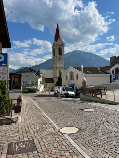 Der Dorfplatz von Glurns mit Kopfsteinpflaster und Kirchturm