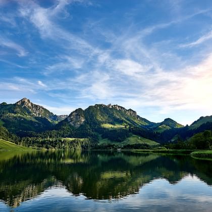 Lake Schwarzsee surrounded by green mountains in the background