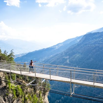 Hikers on an airy suspension bridge