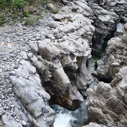 Ein Fluss schlängelt sich durch speziell geformte helle Felsen.