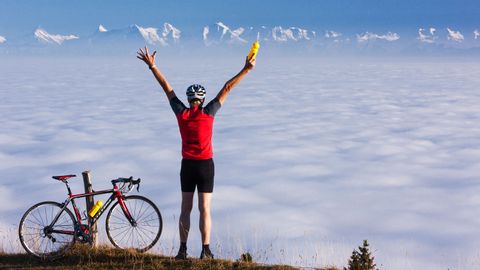 Cyclist celebrating his success. Jura route. Cycling holidays with Eurotrek.