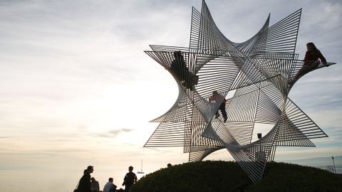 Children have climbed a star-shaped sculpture.