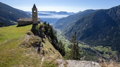 The church of San Romerio with a view of Brusio down in the valley.