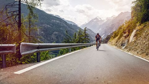 Cyclist on a tarmac road in the mountains