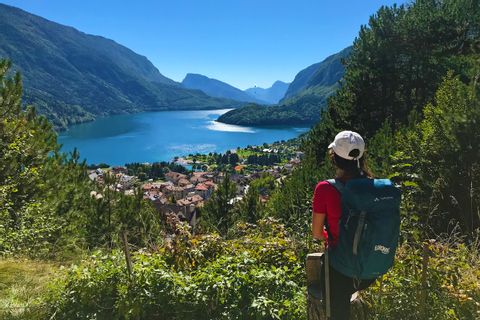 Hiker looks out over the magnificent Molveno Lake