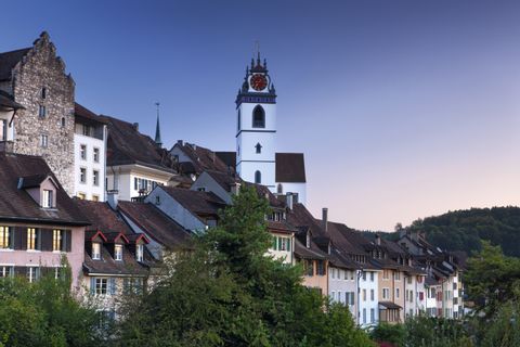 A tall church tower rises above the old town centre of Aarau.