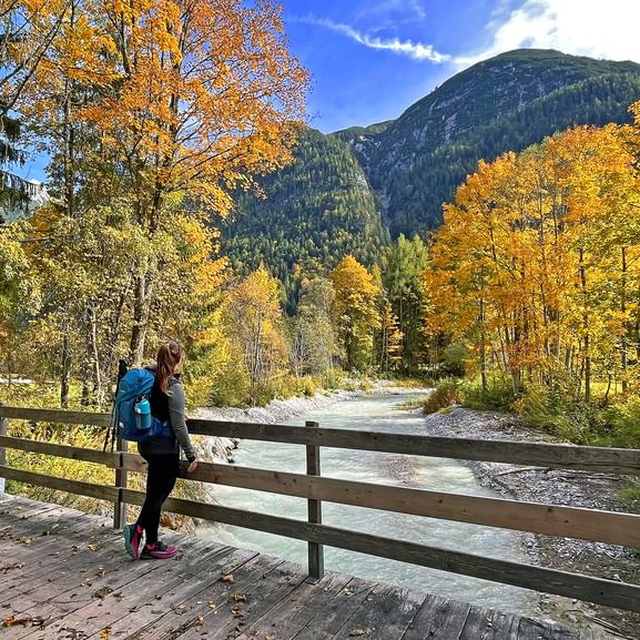 Hiker on the Leutasch bridge autumn forest